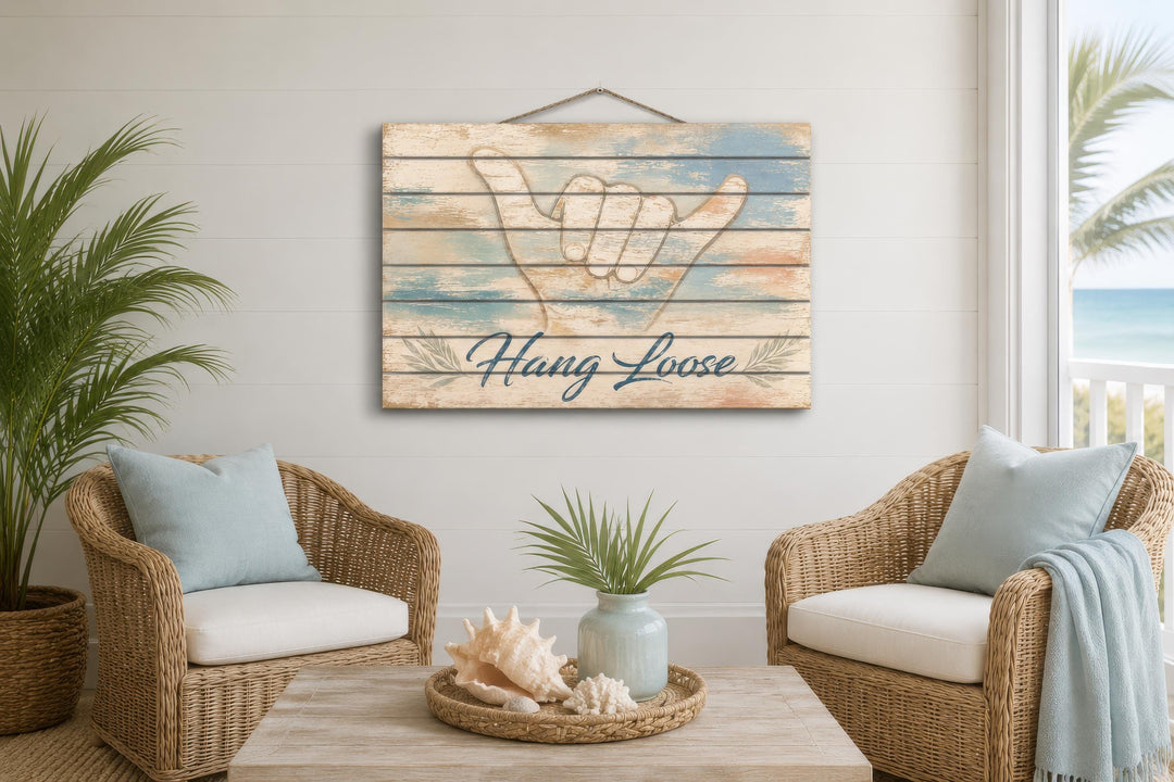 Hang Loose Shaka Sign distressed wood wall art hanging in a coastal-themed living room.