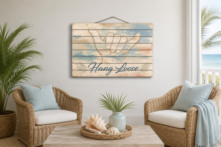 Hang Loose Shaka Sign distressed wood wall art hanging in a coastal-themed living room.