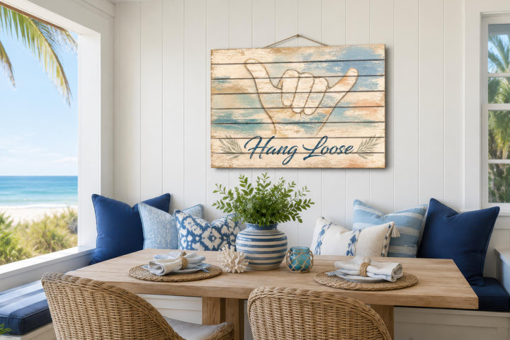 Hang Loose Shaka Sign distressed wood wall art hanging in a coastal-themed dining room.