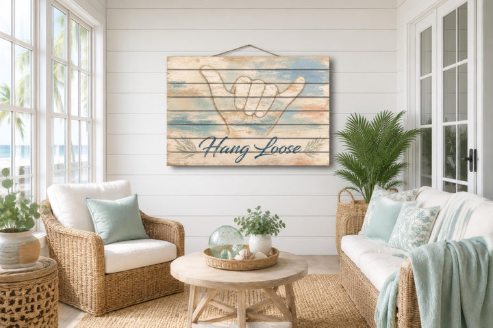 Hang Loose Shaka Sign distressed wood wall art hanging in a coastal-style living room.