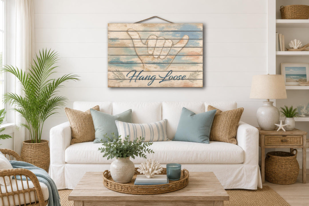 Hang Loose Shaka Sign distressed wood wall art hanging in a coastal-themed living room.