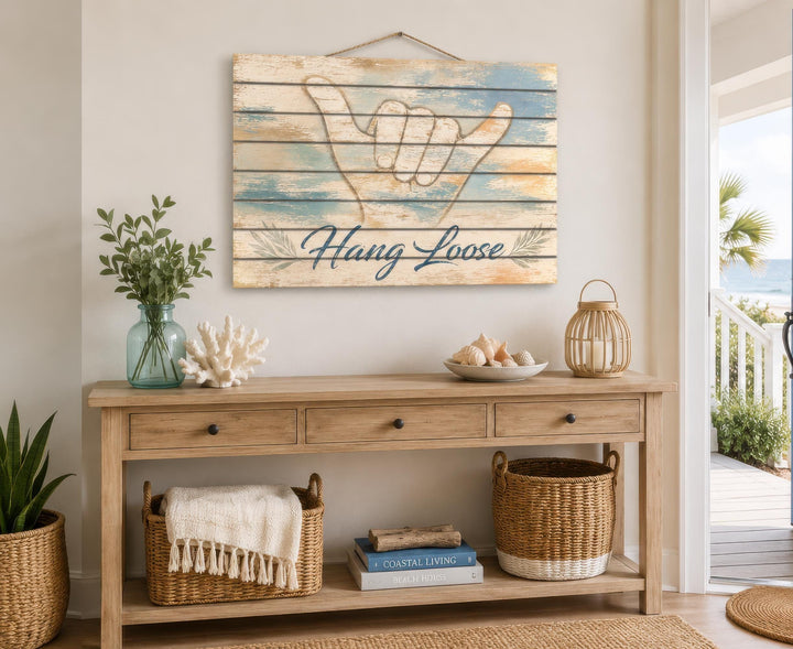Hang Loose Shaka Sign distressed wood wall art hanging above a coastal-style console table.