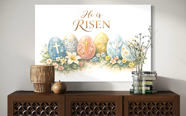 He Is Risen wall art featuring a floral Easter canvas print with crosses and a dove on a sideboard.