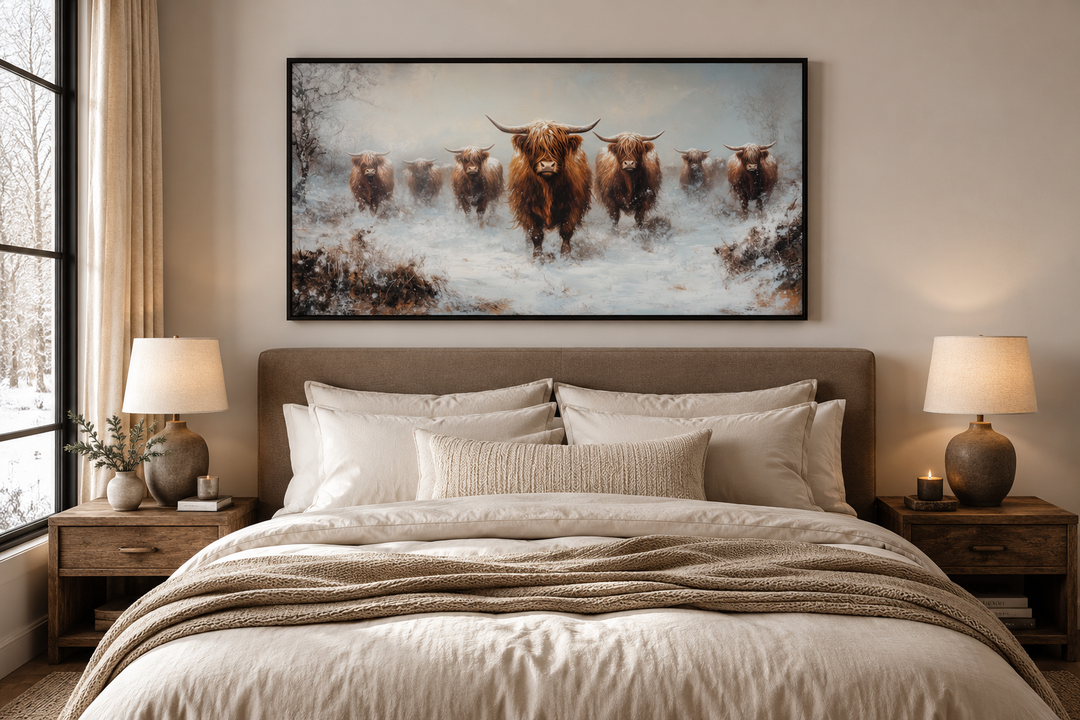 Herd of Highland cows in a snowy field framed canvas wall art hanging above a bed.