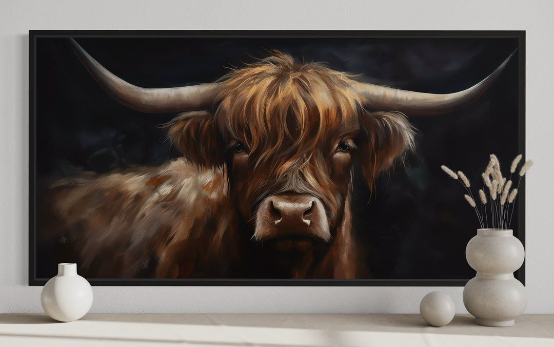 Framed canvas wall art of a Highland cow on a black background with rustic farmhouse decor.