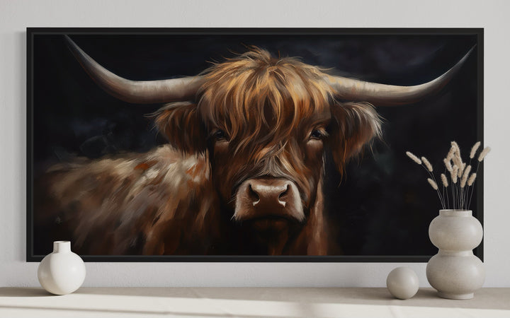 Framed canvas wall art of a Highland cow on a black background with rustic farmhouse decor.
