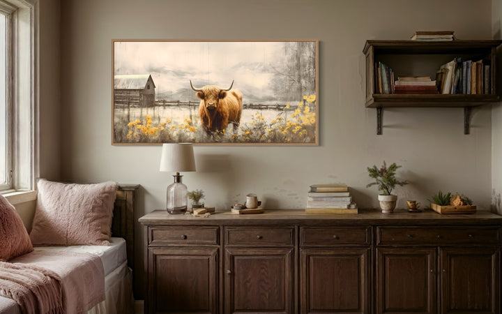 Framed Highland cow canvas wall art above a rustic wooden sideboard in a farmhouse-style room.