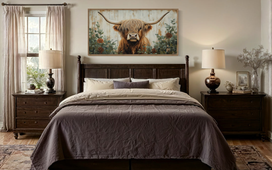 Highland Cow with flowers on distressed wood framed canvas wall art above a bed in a farmhouse room.