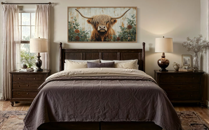 Highland Cow with flowers on distressed wood framed canvas wall art above a bed in a farmhouse room.