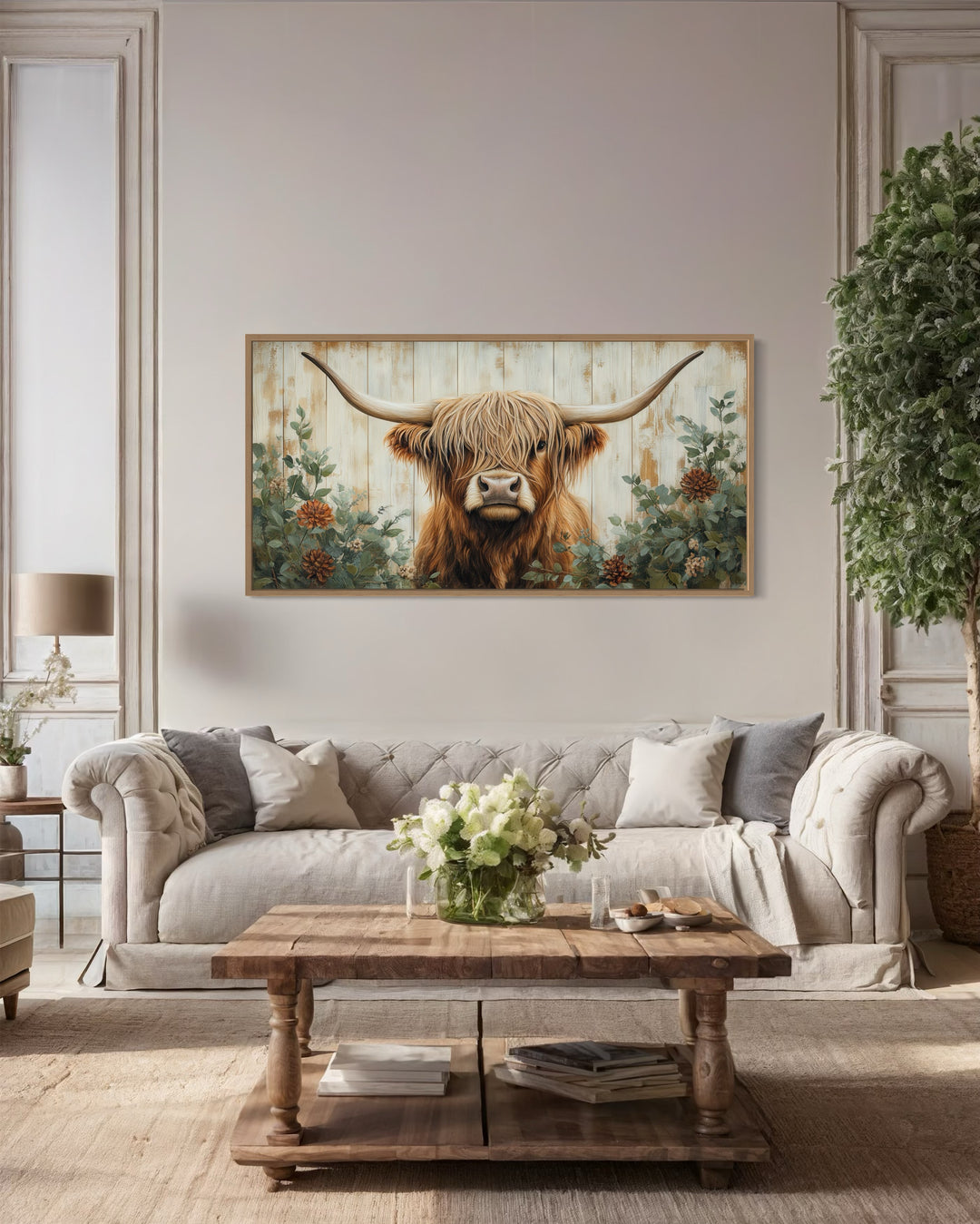 Highland cow with flowers on distressed wood framed canvas wall art in a farmhouse living room.
