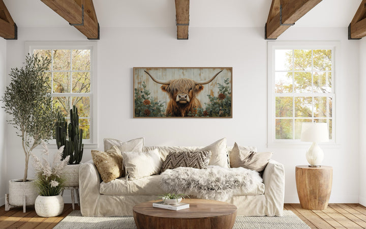 Highland Cow with flowers on distressed wood framed canvas wall art in a farmhouse living room.