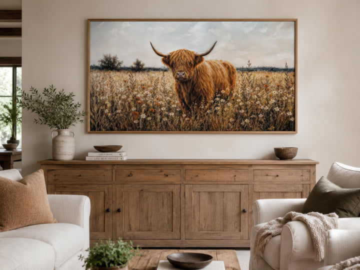 Highland cow in a golden wildflower meadow canvas print in a rustic farmhouse living room.