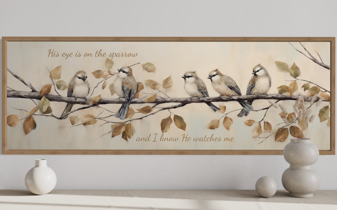 Framed canvas wall art of five sparrows on a branch with scripture text in a neutral-toned room.
