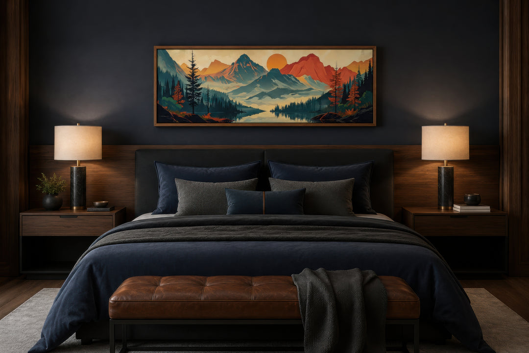 Horizontal canvas wall art of a mountain, forest, and lake landscape above a bed in a dark bedroom.
