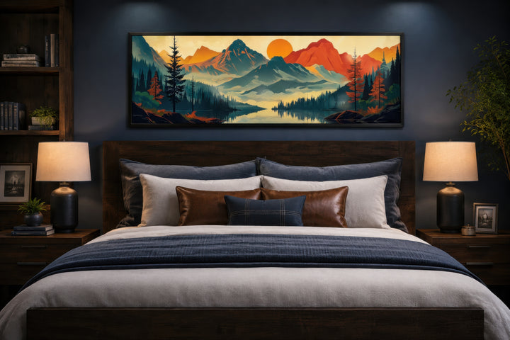 Mid-century modern horizontal canvas art of mountains, forest, and lake hanging above a dark bed.