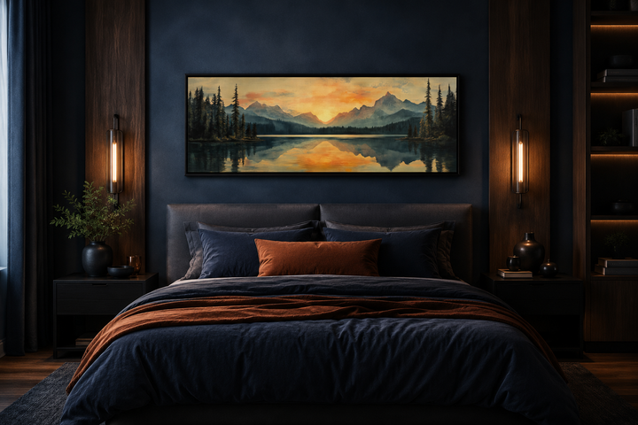 Panoramic mountain lake sunset wall art hanging above a bed in a modern dark blue bedroom.