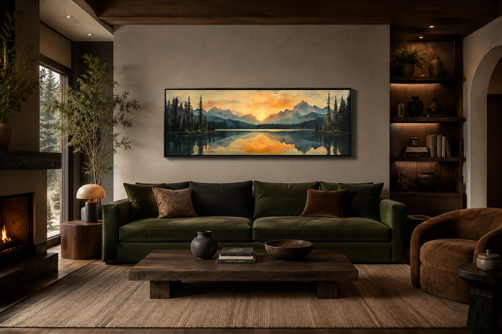 Panoramic mountain lake sunset wall art in a mid-century modern living room above a green sofa.