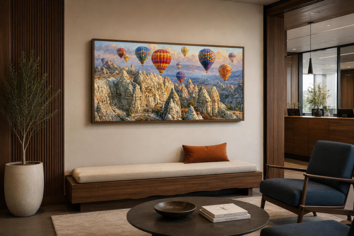 A wide horizontal canvas print of colorful hot air balloons over the Cappadocia landscape.