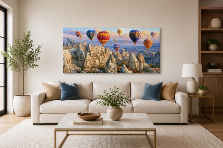 A wide horizontal canvas print of colorful hot air balloons over the Cappadocia landscape.