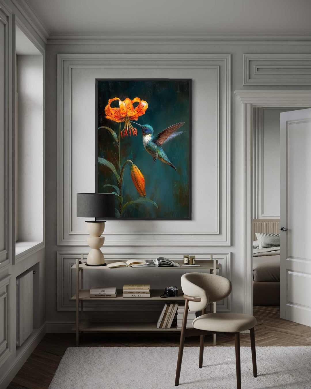 A framed canvas print of a hummingbird and orange lily hangs in a modern, neutral-toned room.