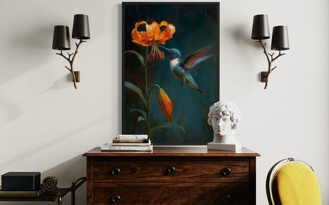 A framed canvas print of a hummingbird and orange lily hangs above a vintage wooden dresser.