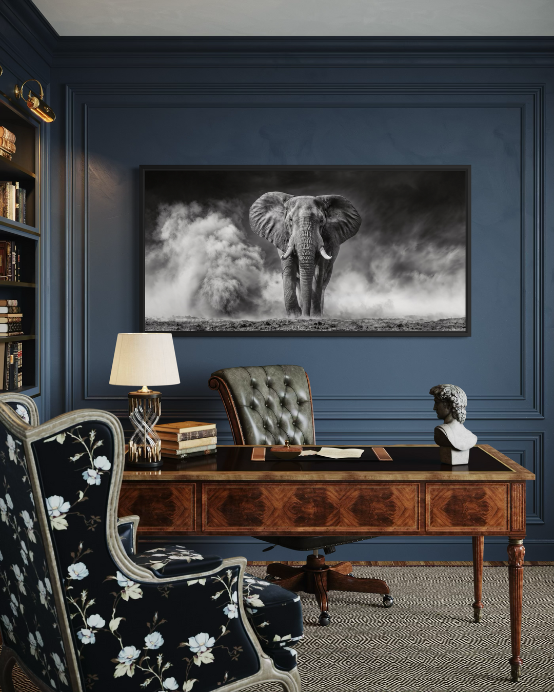 Framed black and white elephant photography canvas print displayed in a classic home office.