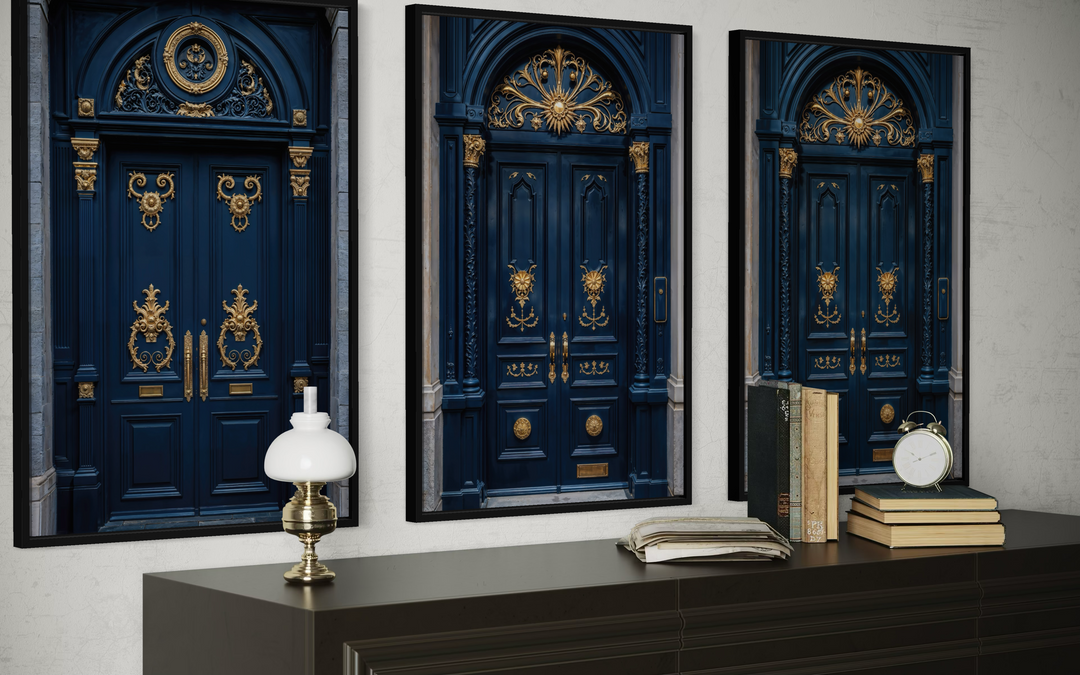 Set of three framed navy blue and gold European door canvas prints on a wall above a sideboard.