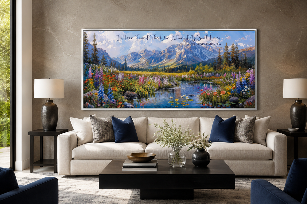 Christian scripture wall art with mountain landscape above a sofa in a modern living room.