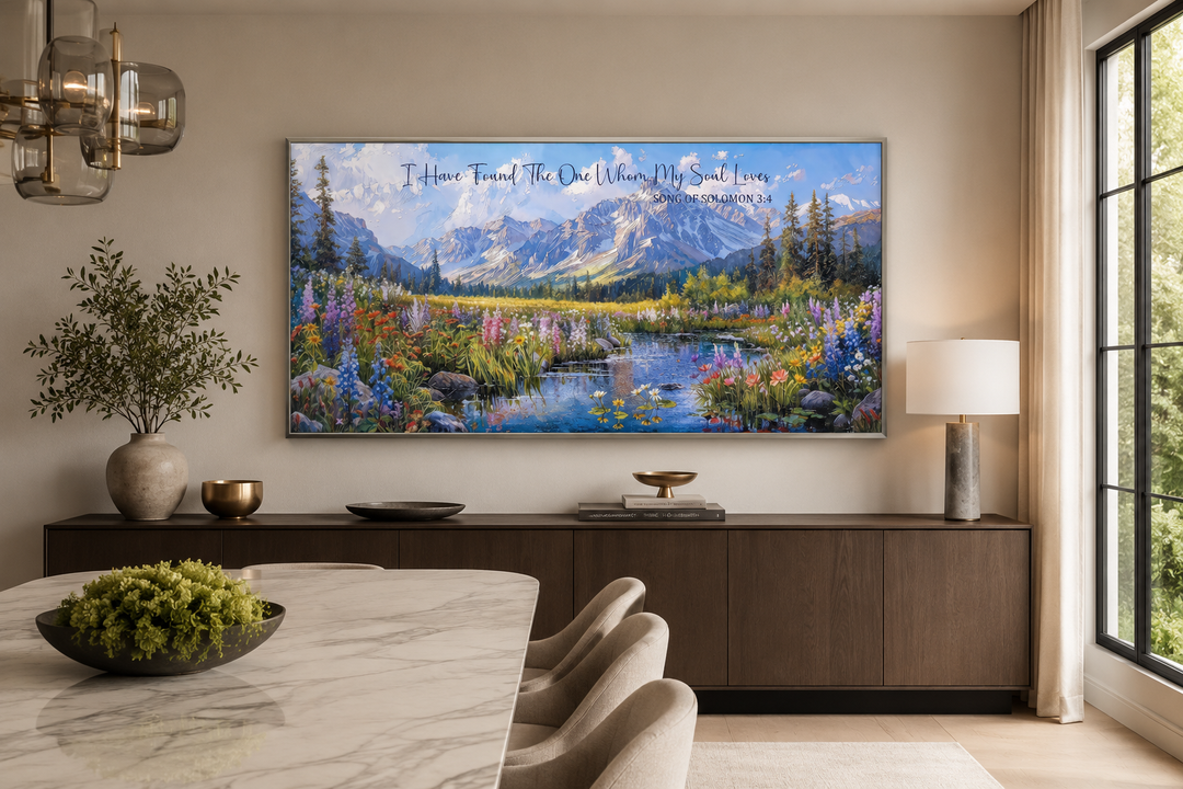 Christian wall art with mountain landscape and scripture above a modern sideboard in a dining room.
