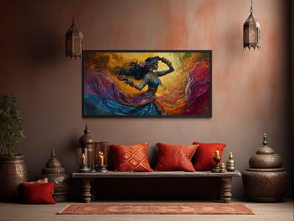 A colorful canvas print of an Indian dancer in motion hangs above a bench with red pillows.