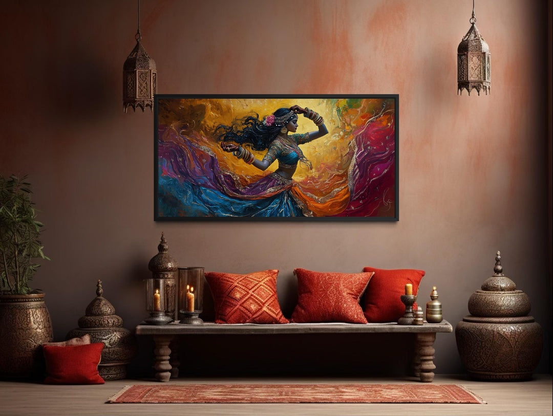 A colorful canvas print of an Indian dancer in motion hangs above a bench with red pillows.