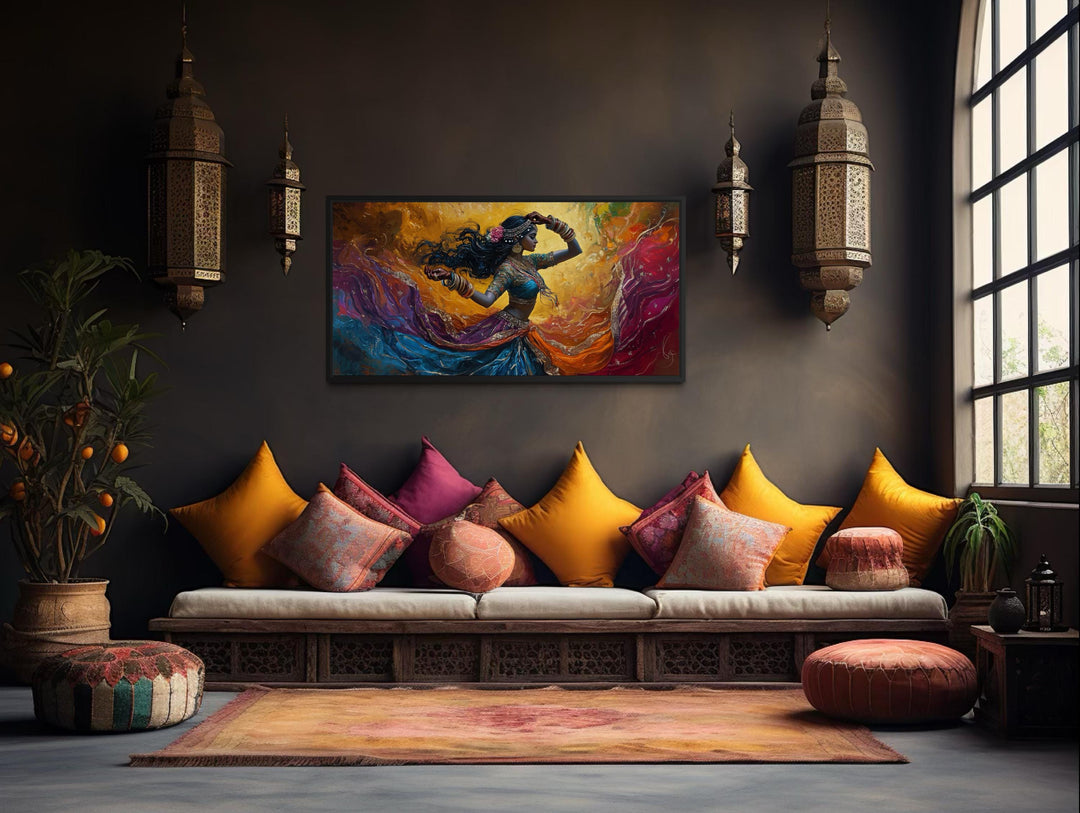 A colorful canvas print of an Indian dancer hangs in a bohemian living room with vibrant cushions.