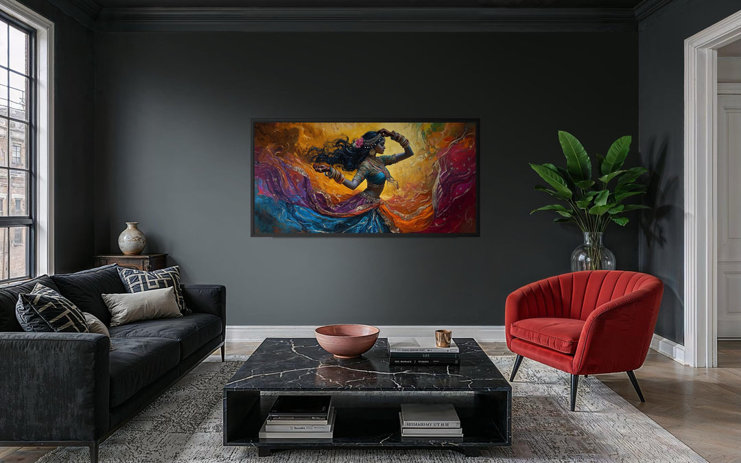 A colorful canvas print of an Indian dancer in motion hangs in a modern, dark-toned living room.