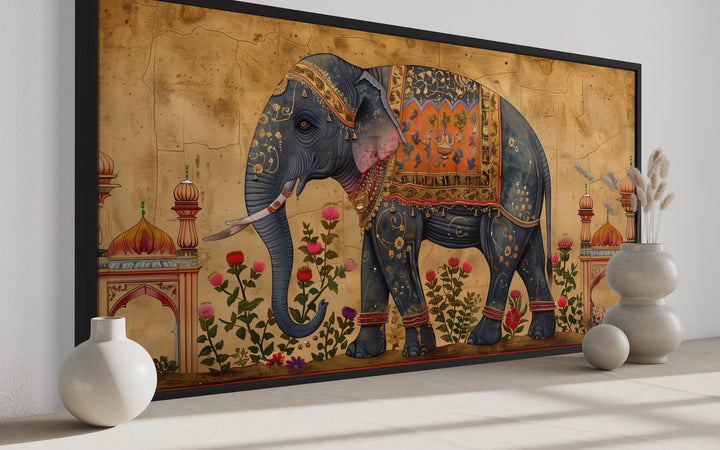Framed canvas wall art of a decorated Indian elephant with traditional motifs and floral accents.
