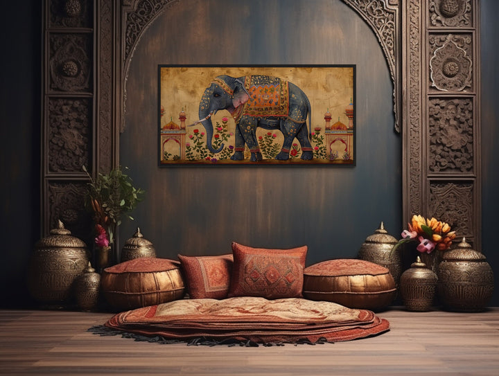 Framed canvas wall art of a decorated Indian elephant in a traditional, ornate room setting.