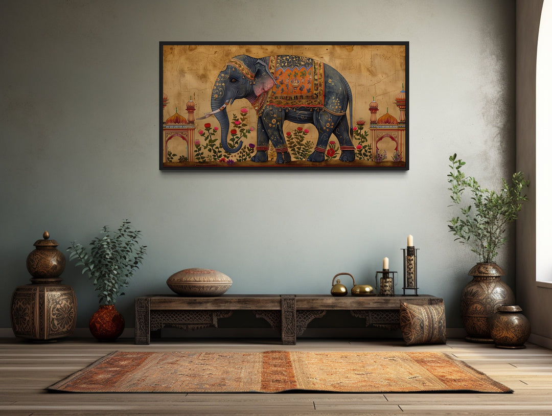 Framed canvas wall art of a decorated Indian elephant in a traditional room setting.