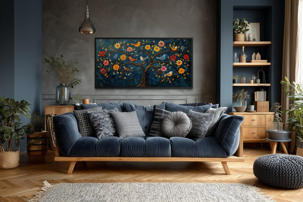 Madhubani Tree of Life canvas wall art featuring colorful birds and flowers above a blue sofa.