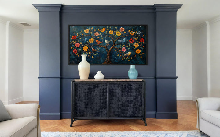 Madhubani Tree of Life canvas wall art featuring colorful birds and flowers on a dark blue background.