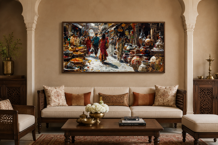 Framed Indian market painting on a living room wall above a beige sofa with decorative pillows.