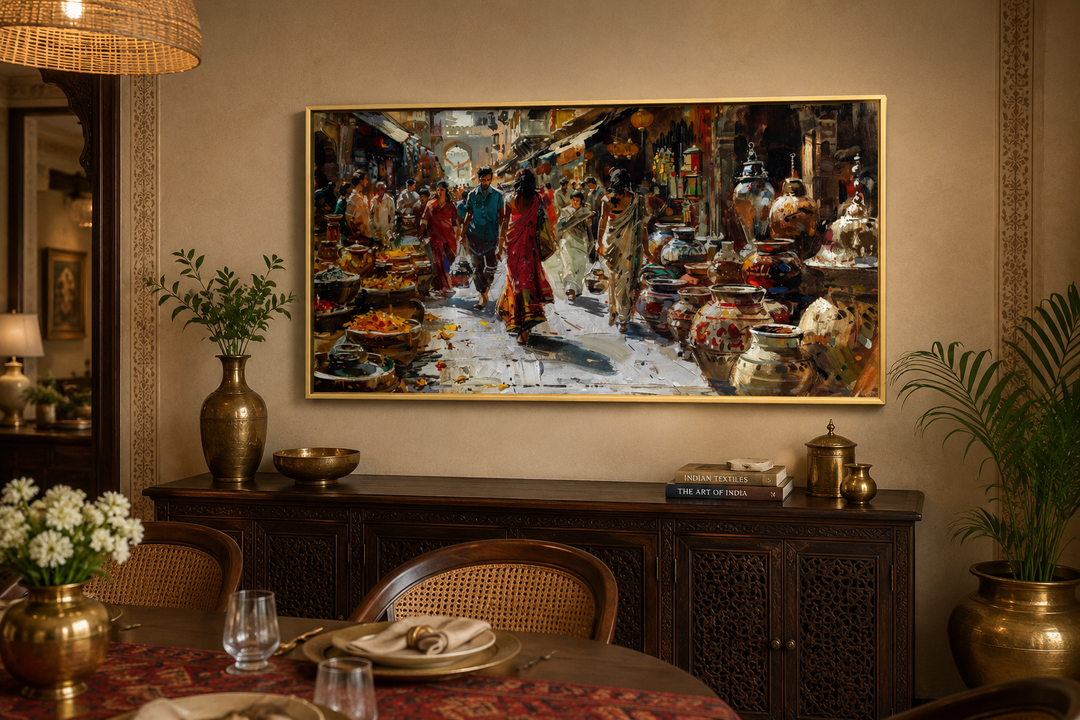 Framed canvas painting of a vibrant Indian bazaar scene above a dark wood sideboard.