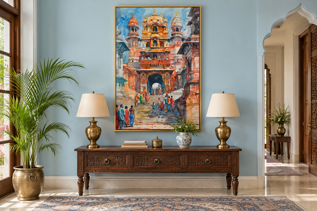 Framed canvas wall art of a vibrant Indian temple scene with people, hung above a wooden console.