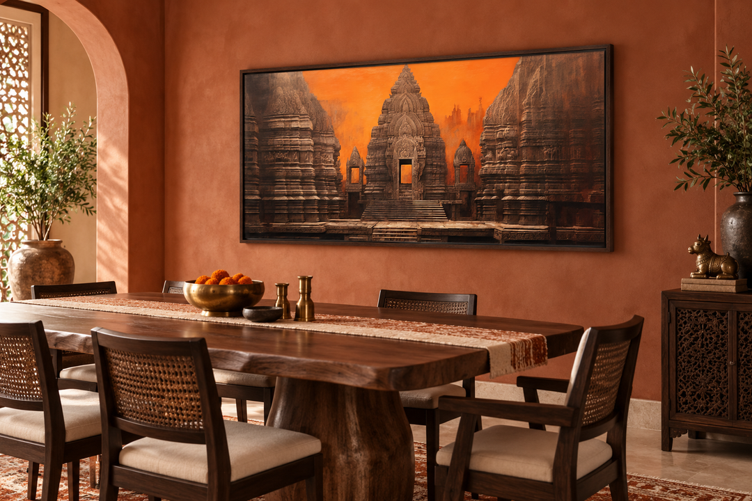 Framed canvas print of an ancient Indian temple at sunset in orange and brown tones above a table.