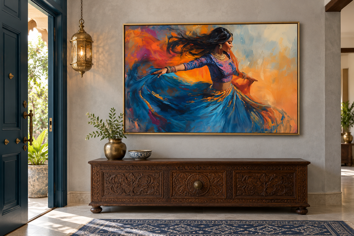 Indian woman dancing framed canvas wall art in a gold frame above a carved wooden console table.