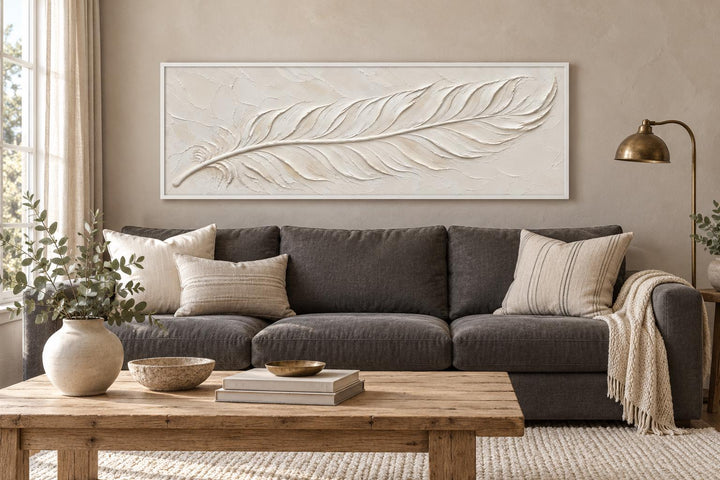 Long narrow canvas wall art featuring a textured ivory feather on a neutral cream background.