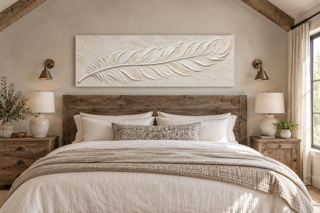 Long narrow canvas wall art featuring a sculpted ivory feather with a cream plaster effect.