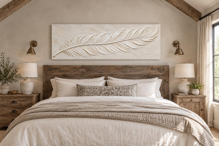 Long narrow canvas wall art featuring a sculpted ivory feather with a cream plaster effect.