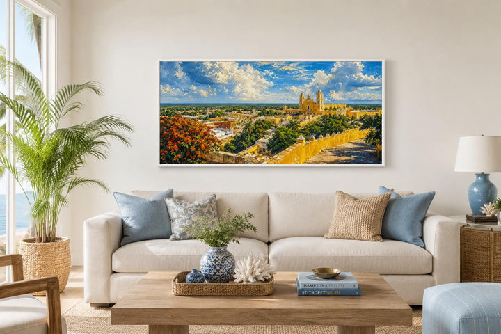 Izamal Cityscape canvas wall art featuring yellow colonial buildings above a white sofa.