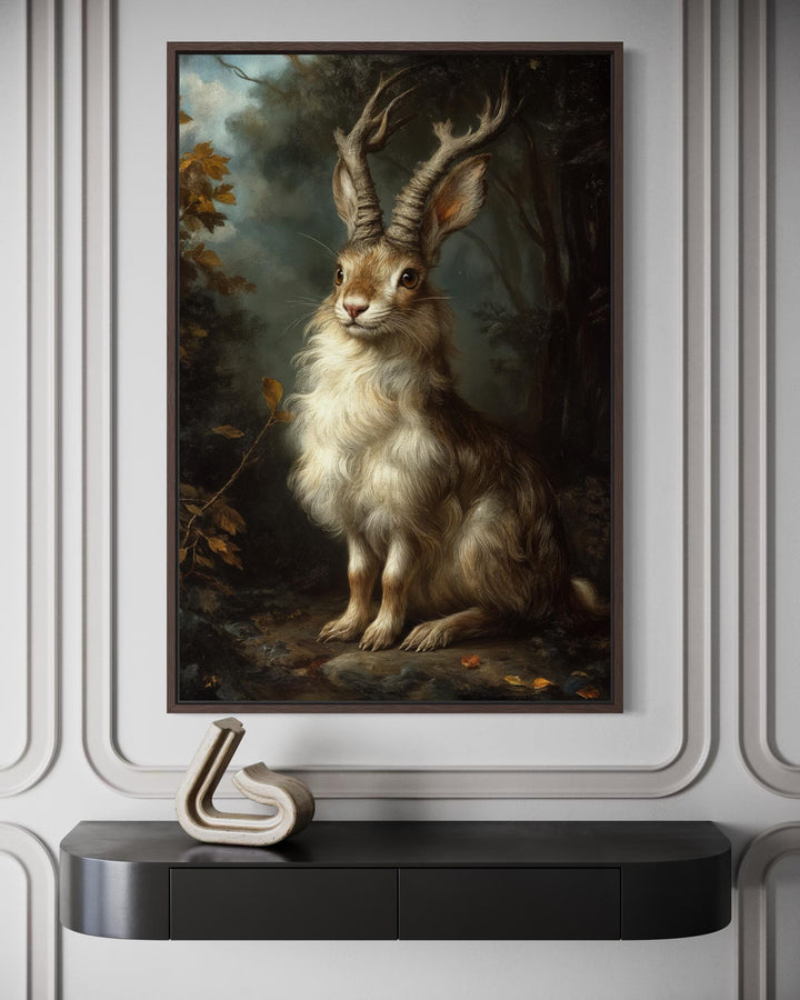 A framed canvas portrait of a majestic jackalope in a dark, moody forest setting.
