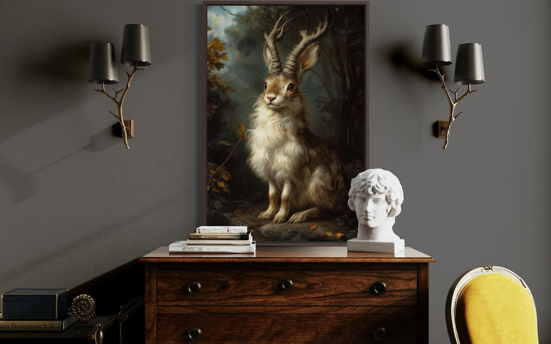 Jackalope canvas wall art in a dark moody forest setting, framed and hung in a rustic room.