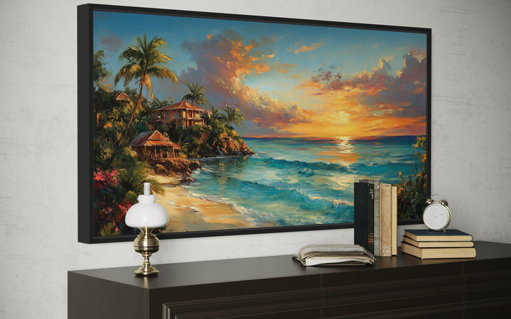 Jamaican Sunset Beach Framed Canvas Wall Art above a dark wood dresser with books and a lamp.